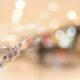 A blurred background with a hand holding a smartphone showcasing interconnected digital icons, symbolizing seamless communication through VoIP phone systems Dallas.